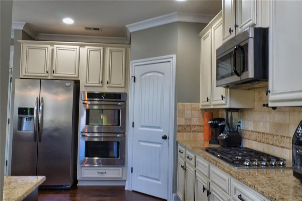 5639 Sunbury Loop Evans, GA 30809 - Photo 10 of 22 a kitchen with stainless steel appliances granite countertop a refrigerator stove and microwave