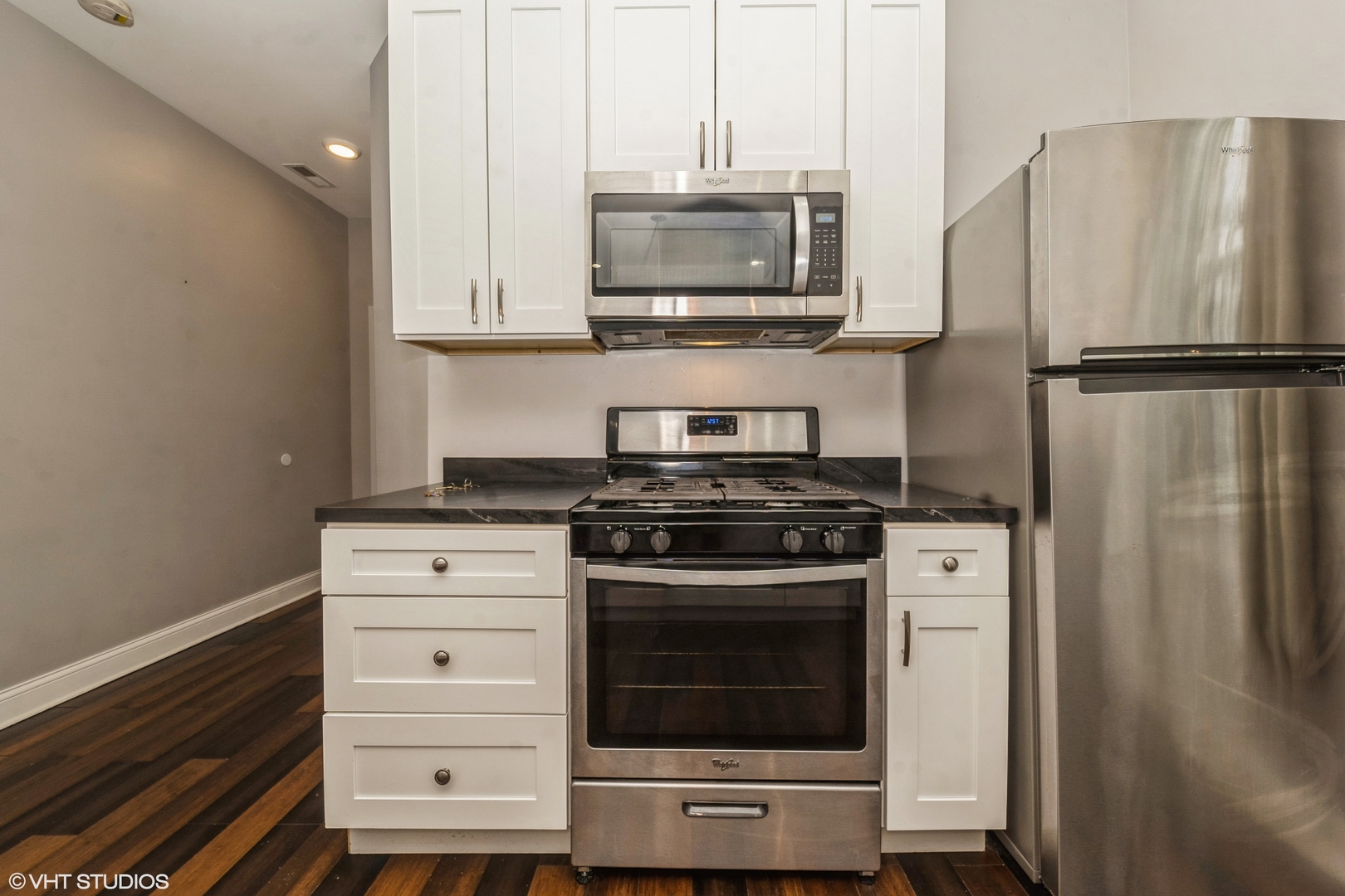2734 West 18th Street, Unit 2R Chicago, IL 60608 - Photo 6 of 10 a kitchen with stainless steel appliances a stove a microwave and a refrigerator