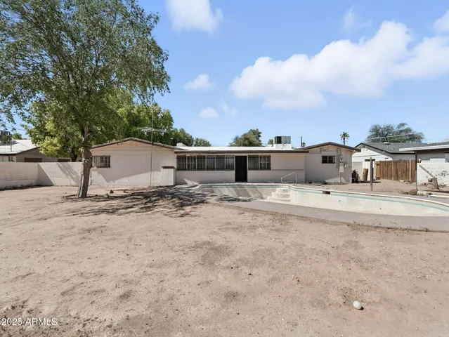 a kitchen with a sink stove window and cabinets
