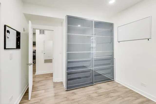 a view of walk in closet with empty racks
