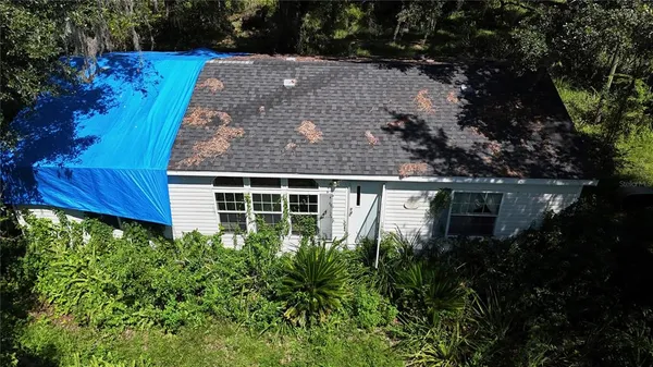 a view of a house with a tree and a yard