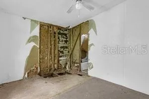 a view of walk in closet with clothes