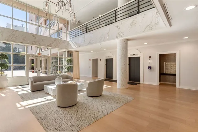 a living room with furniture and a chandelier