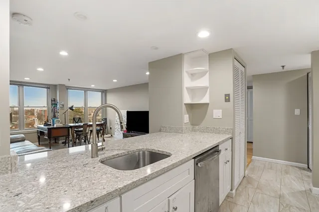a kitchen with kitchen island a sink appliances and a counter top space
