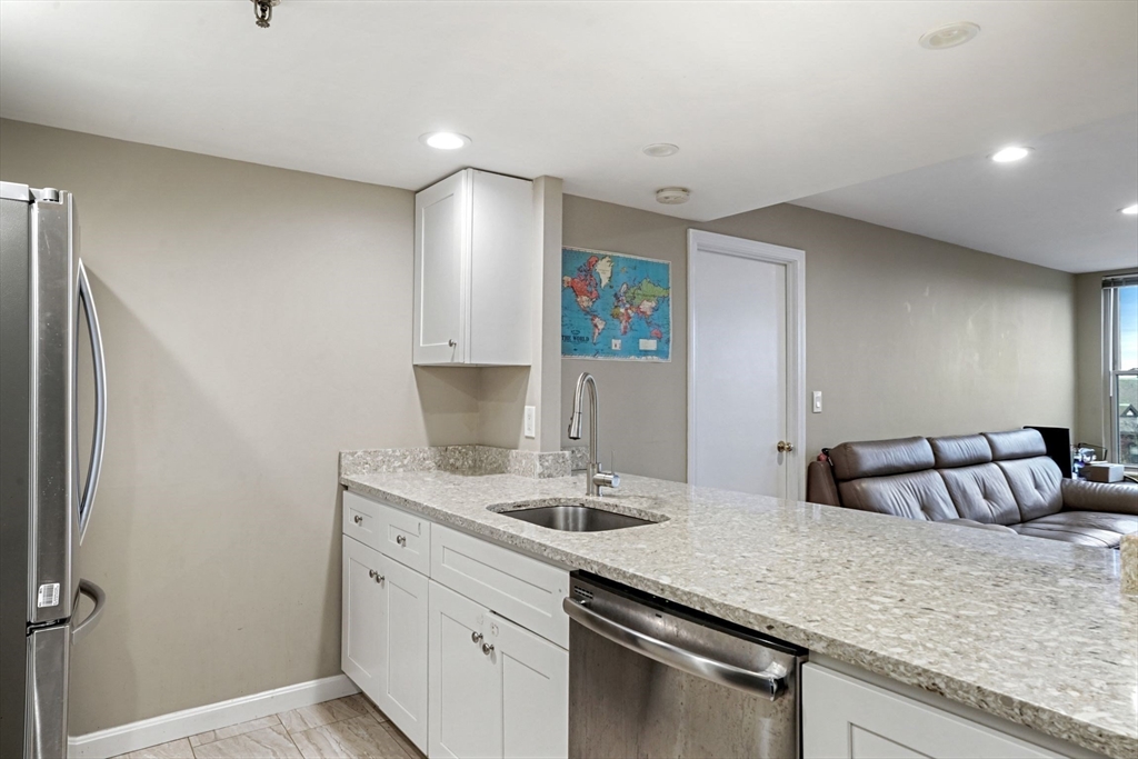 20 Webster Street, Unit 605 Brookline, MA 02446 - Photo 13 of 40 a kitchen with a sink and cabinets