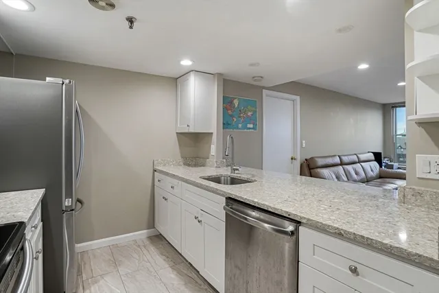 a kitchen with a sink and a refrigerator