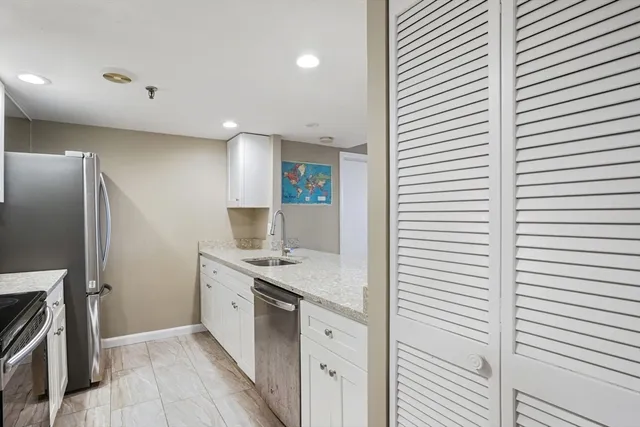 a kitchen with a sink and a refrigerator