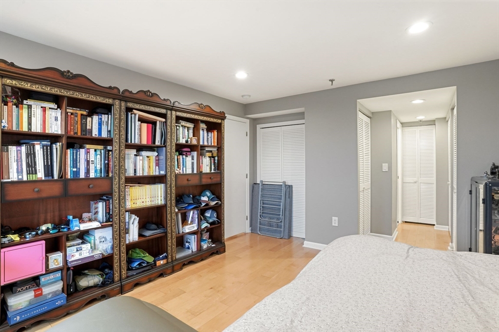 20 Webster Street, Unit 605 Brookline, MA 02446 - Photo 19 of 40 a bed room with a bed and a book shelf