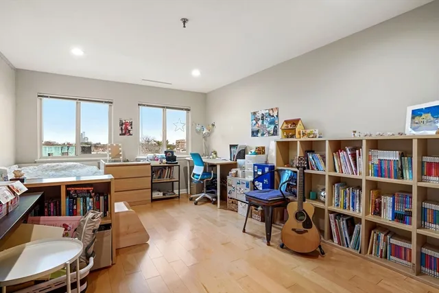 a room with furniture a rug and a book shelf