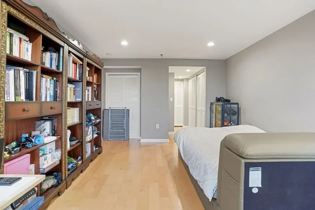 a bedroom with a bed and a book shelf