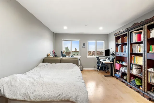 a bed room with a bed and a book shelf