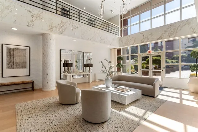 a living room with furniture and a floor to ceiling window