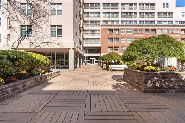 a front view of a building with outdoor seating