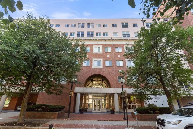 front view of a building with a garden