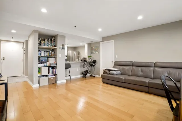 a living room with furniture and a book shelf