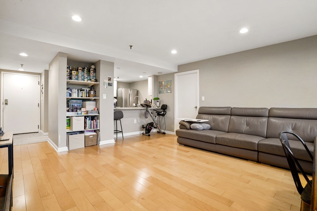 20 Webster Street, Unit 605 Brookline, MA 02446 - Photo 4 of 40 a living room with furniture and a book shelf