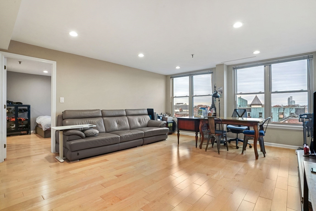 20 Webster Street, Unit 605 Brookline, MA 02446 - Photo 6 of 40 a living room with furniture a dining table and a large window