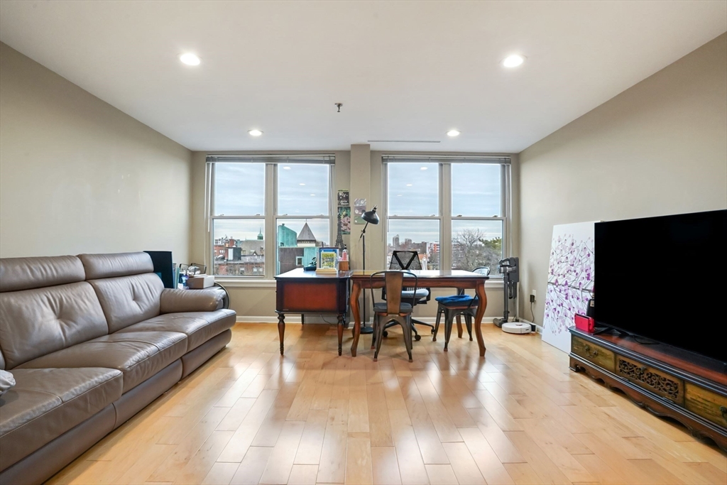 20 Webster Street, Unit 605 Brookline, MA 02446 - Photo 8 of 40 a living room with furniture and a flat screen tv