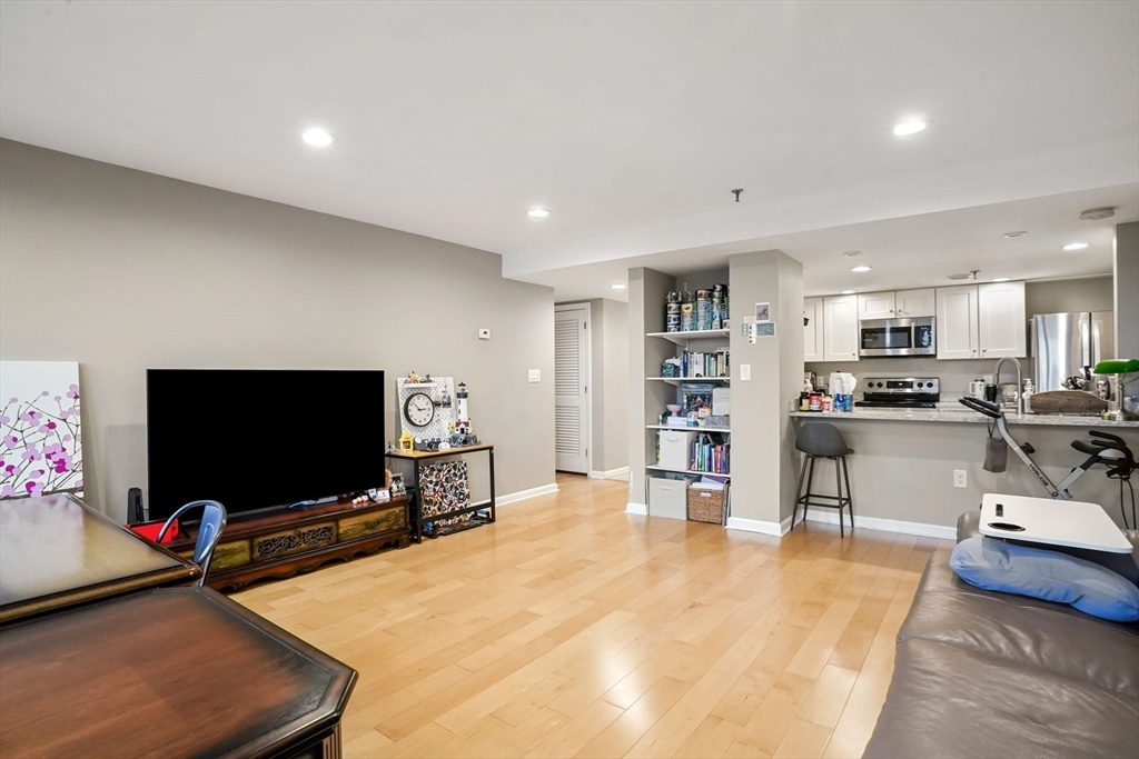 20 Webster Street, Unit 605 Brookline, MA 02446 - Photo 9 of 40 a living room with furniture and a flat screen tv
