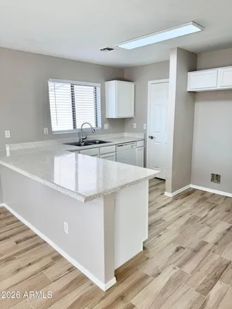 a large kitchen with kitchen island a sink stainless steel appliances and cabinets