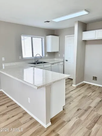 a large kitchen with kitchen island a sink stainless steel appliances and cabinets