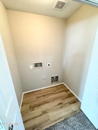 an empty room with windows and chandelier fan