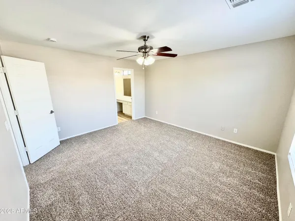 a view of empty room with a fan