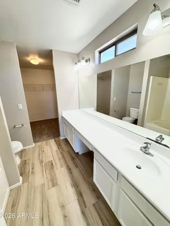 a spacious bathroom with a double vanity sink and a mirror