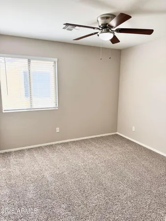 a view of a livingroom with a ceiling fan and a window