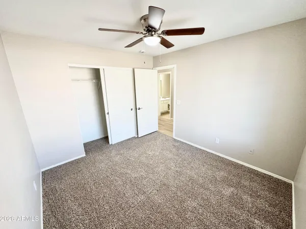 a view of a livingroom with a ceiling fan and wooden floor
