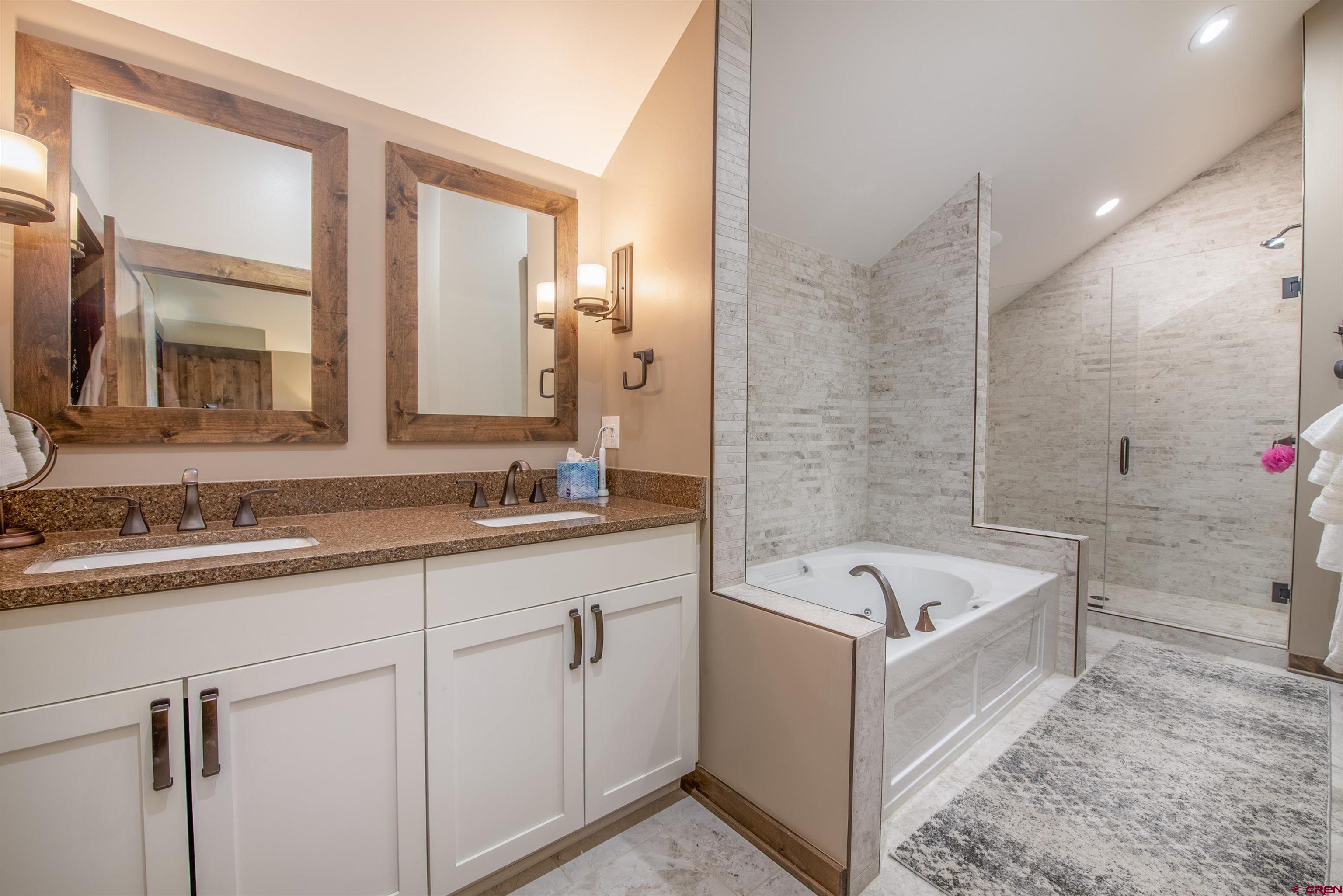 14 Ace Court Crested Butte, CO 81224 - Photo 11 of 24 a bathroom with a tub a sink and mirror