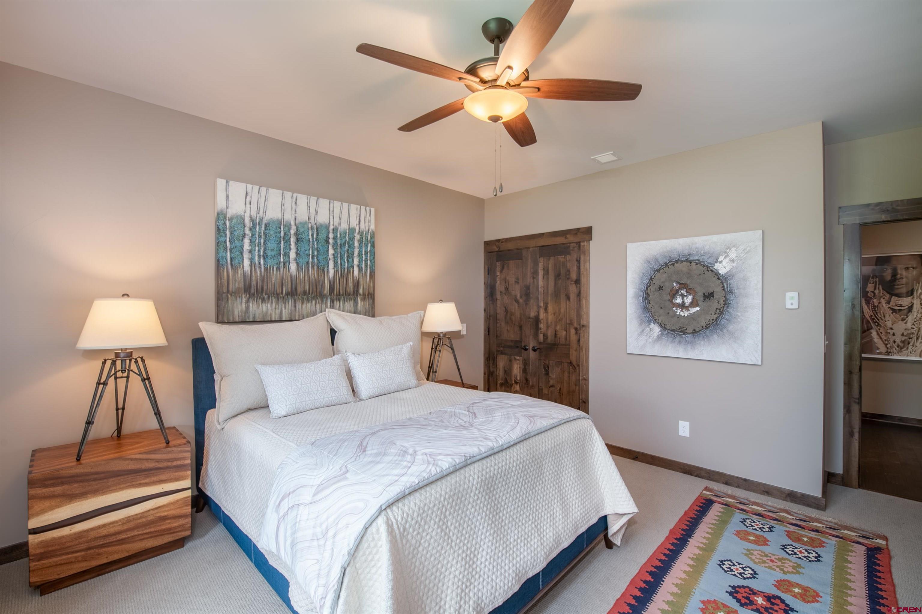 14 Ace Court Crested Butte, CO 81224 - Photo 12 of 24 a bedroom with a bed and a chandelier