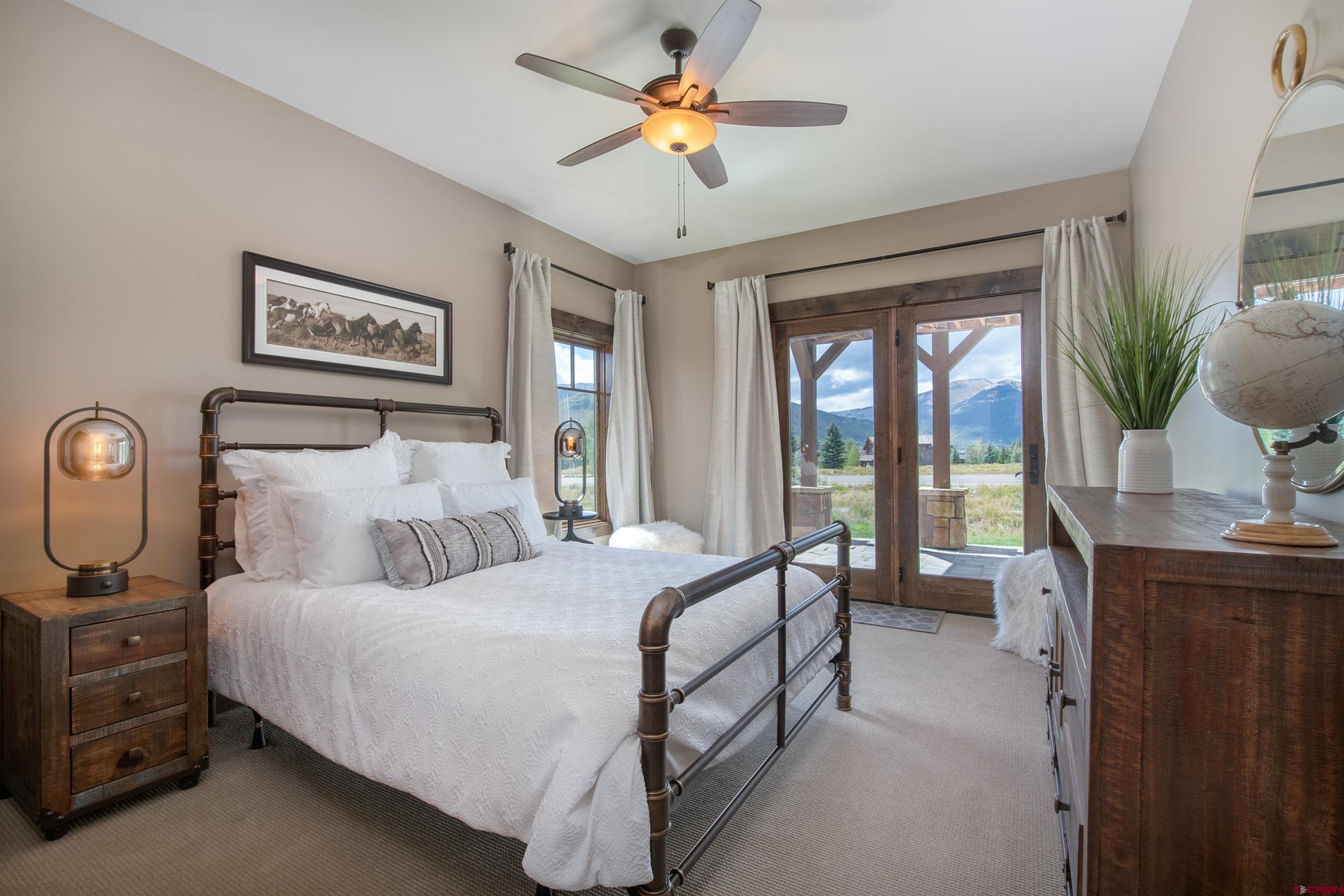 14 Ace Court Crested Butte, CO 81224 - Photo 14 of 24 a bedroom with a balcony a bed and a chandelier