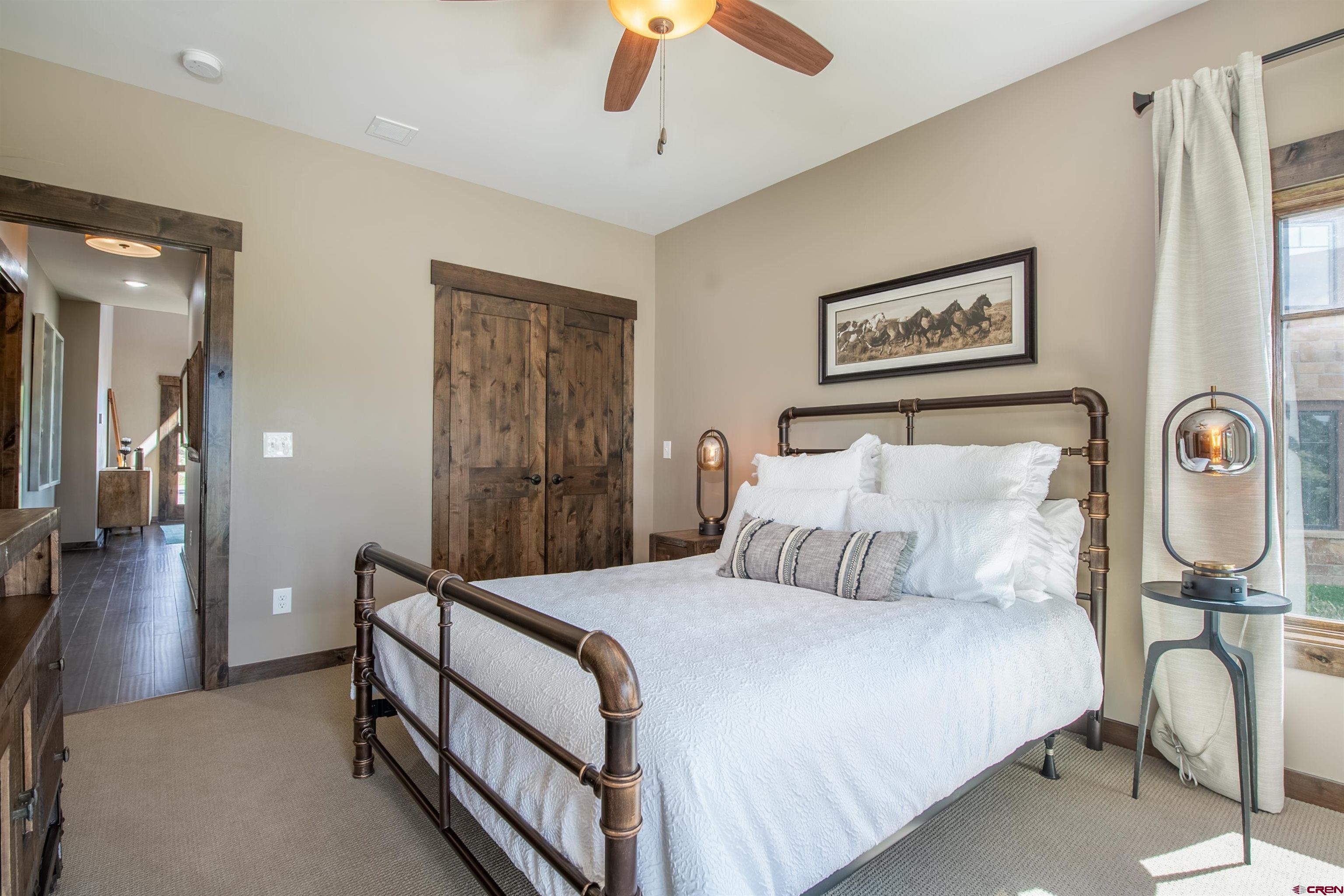 14 Ace Court Crested Butte, CO 81224 - Photo 15 of 24 a bedroom with a bed and a chandelier
