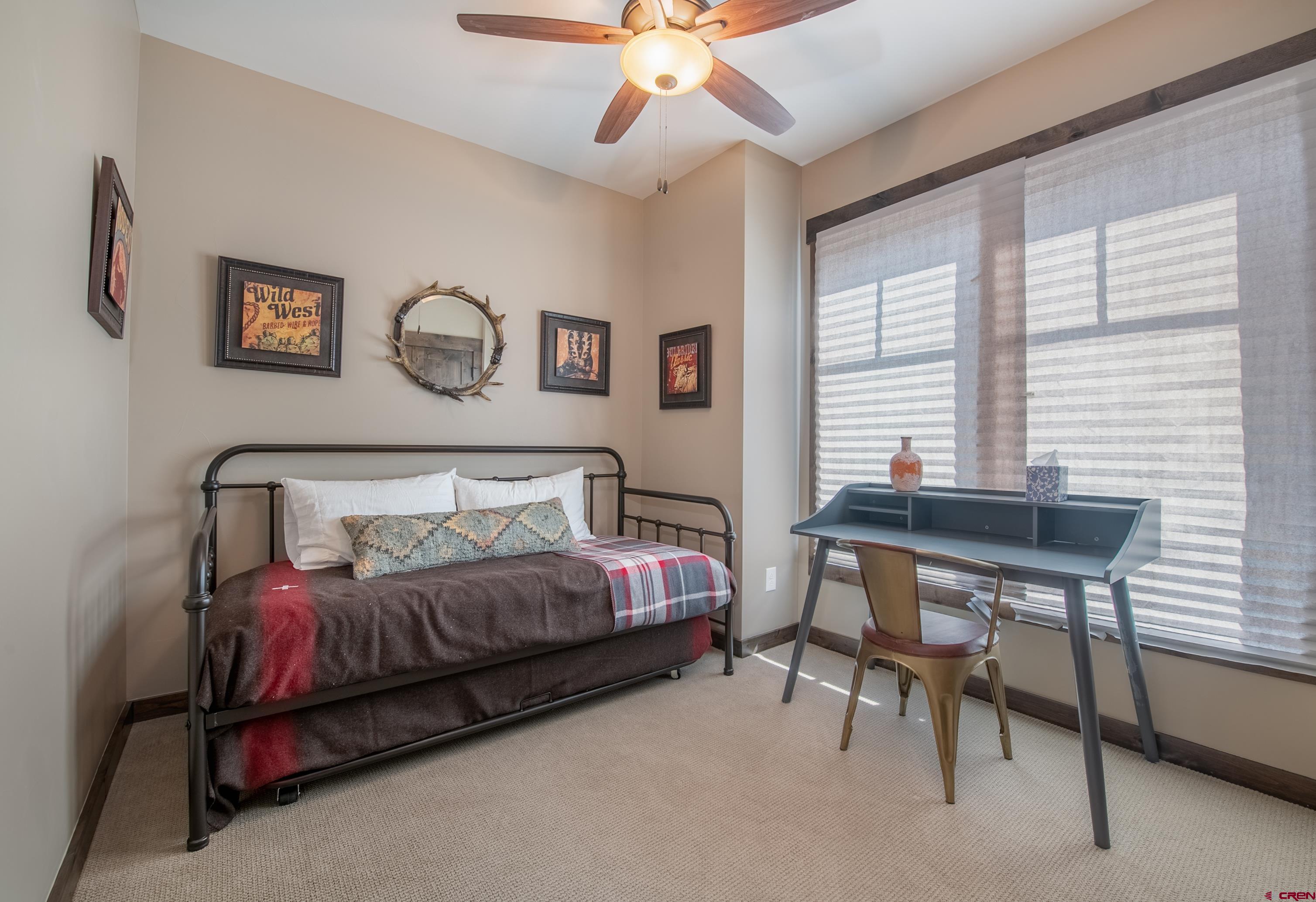 14 Ace Court Crested Butte, CO 81224 - Photo 17 of 24 a bedroom with a bed and a chandelier
