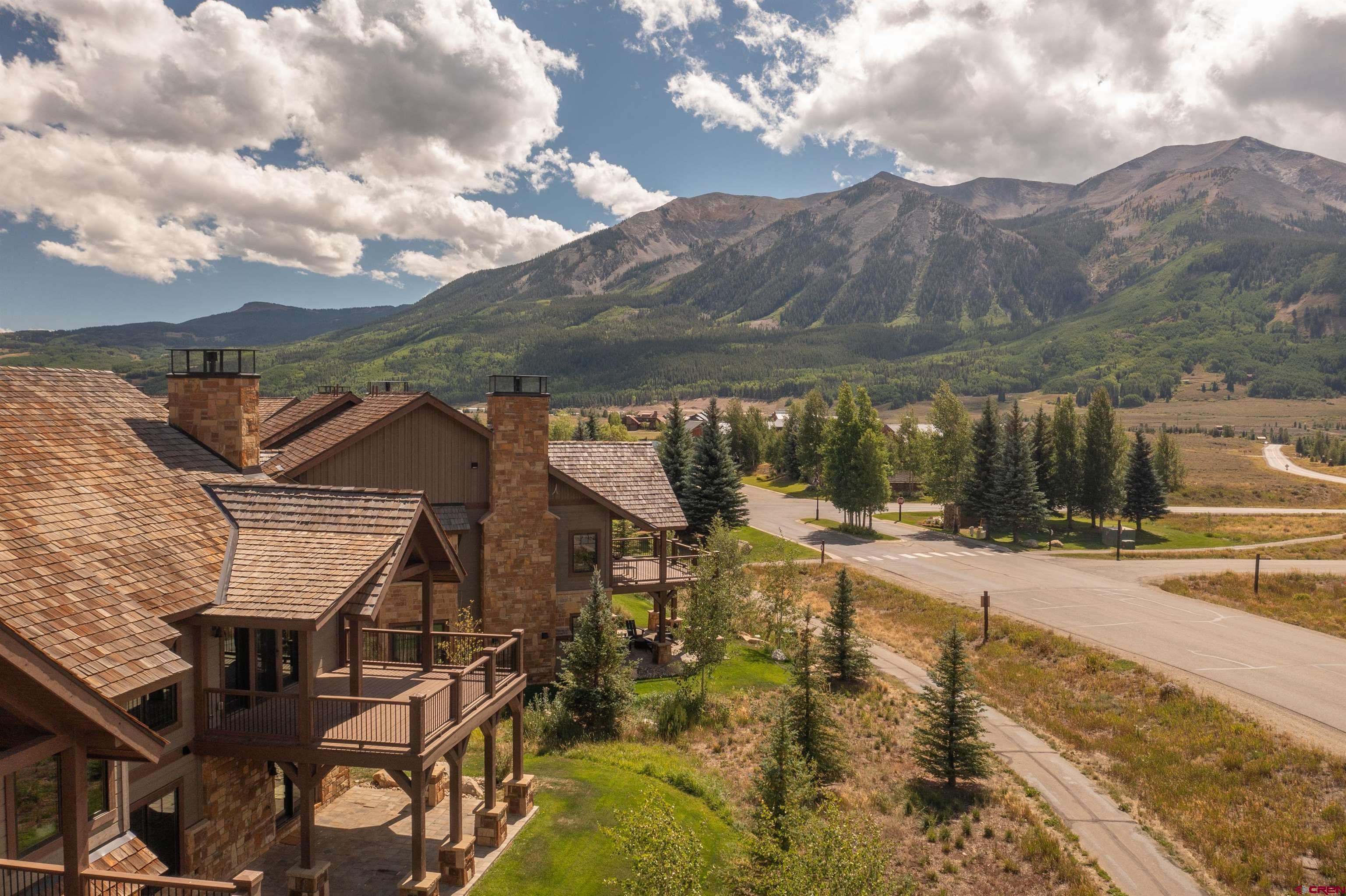 14 Ace Court Crested Butte, CO 81224 - Photo 23 of 24 a view of a white house with a big yard and large tree