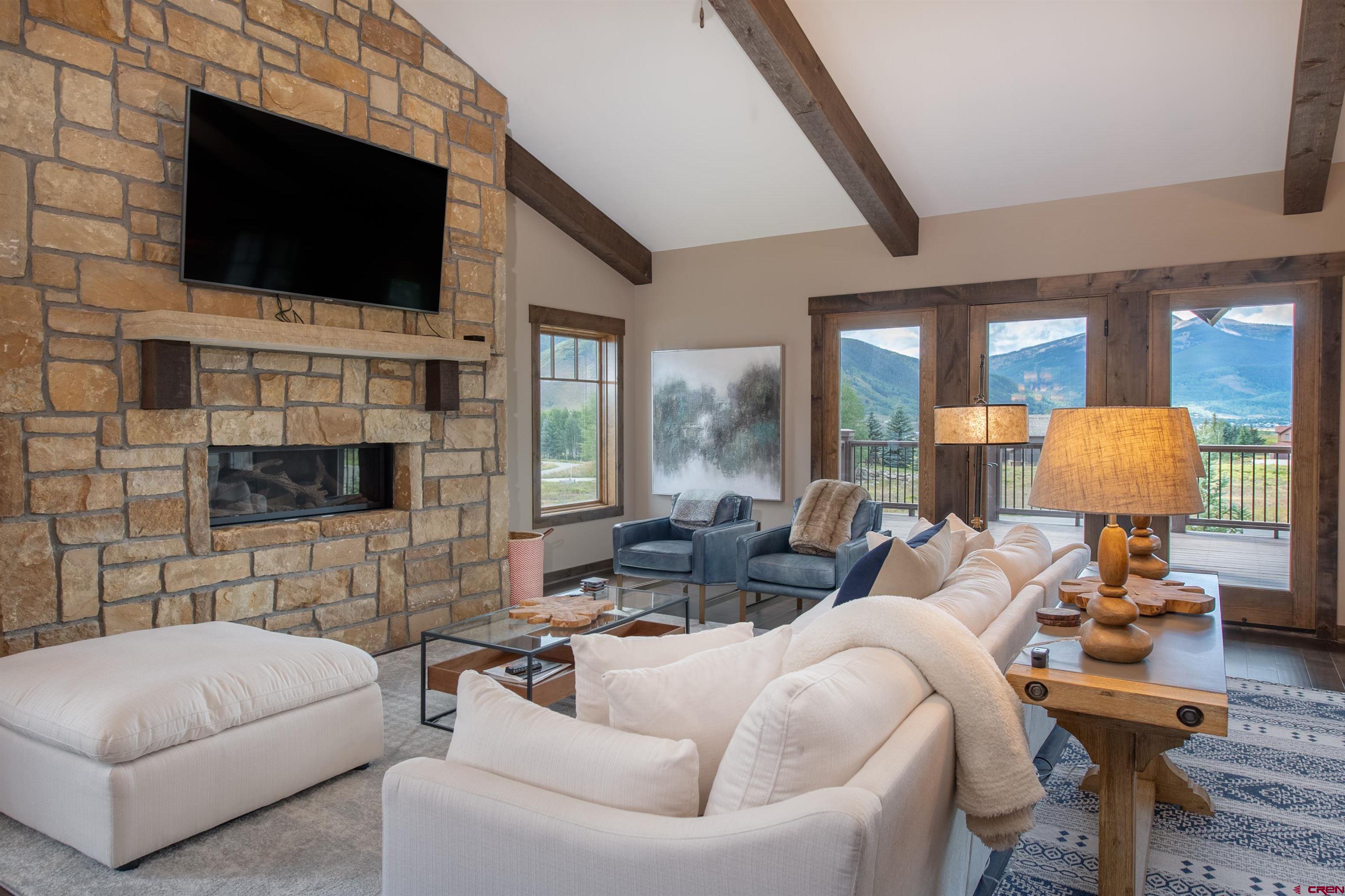 14 Ace Court Crested Butte, CO 81224 - Photo 5 of 24 a living room with fireplace furniture and a flat screen tv