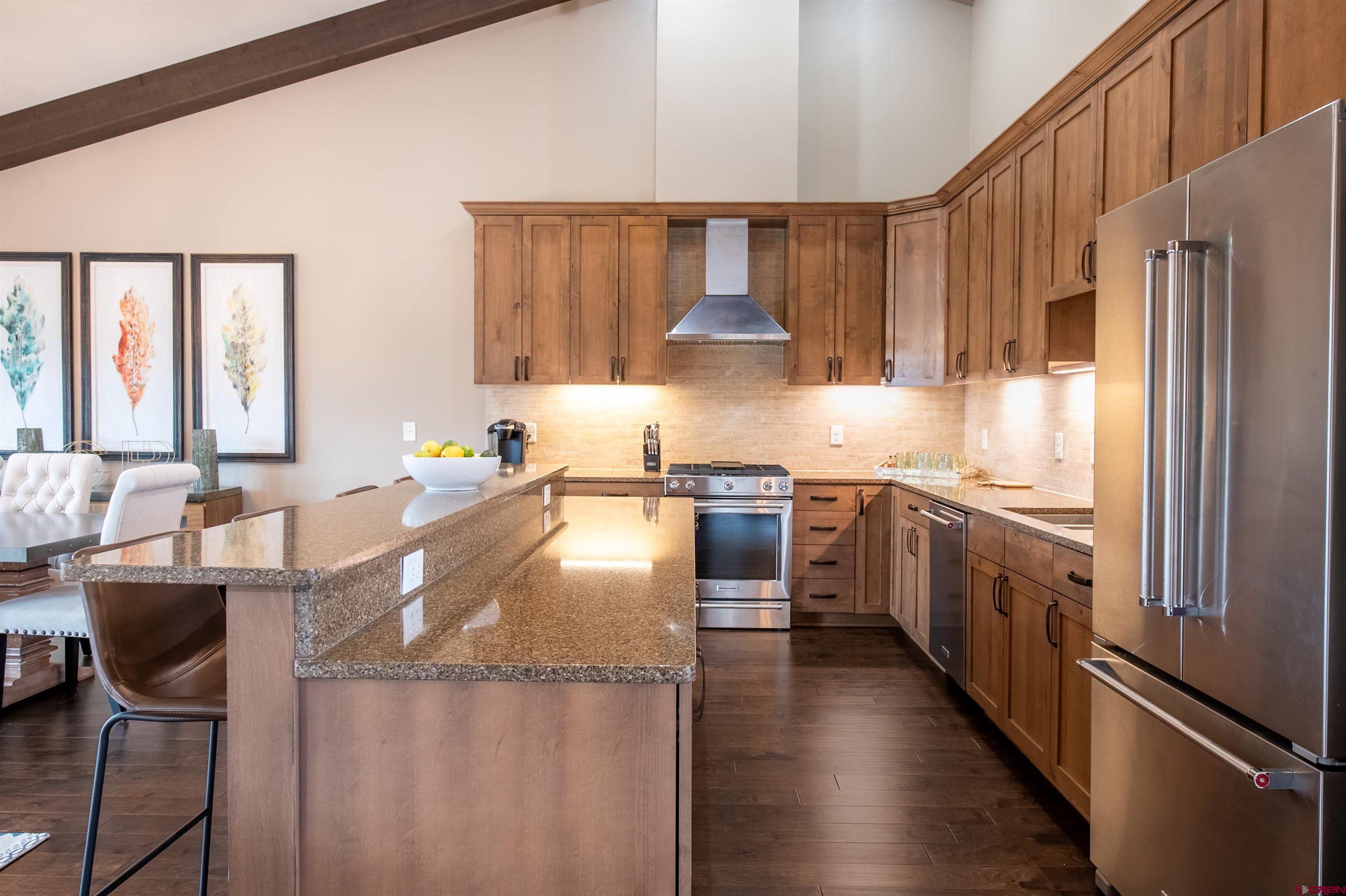 14 Ace Court Crested Butte, CO 81224 - Photo 8 of 24 a kitchen with stainless steel appliances granite countertop a refrigerator a stove and a sink with wooden floor