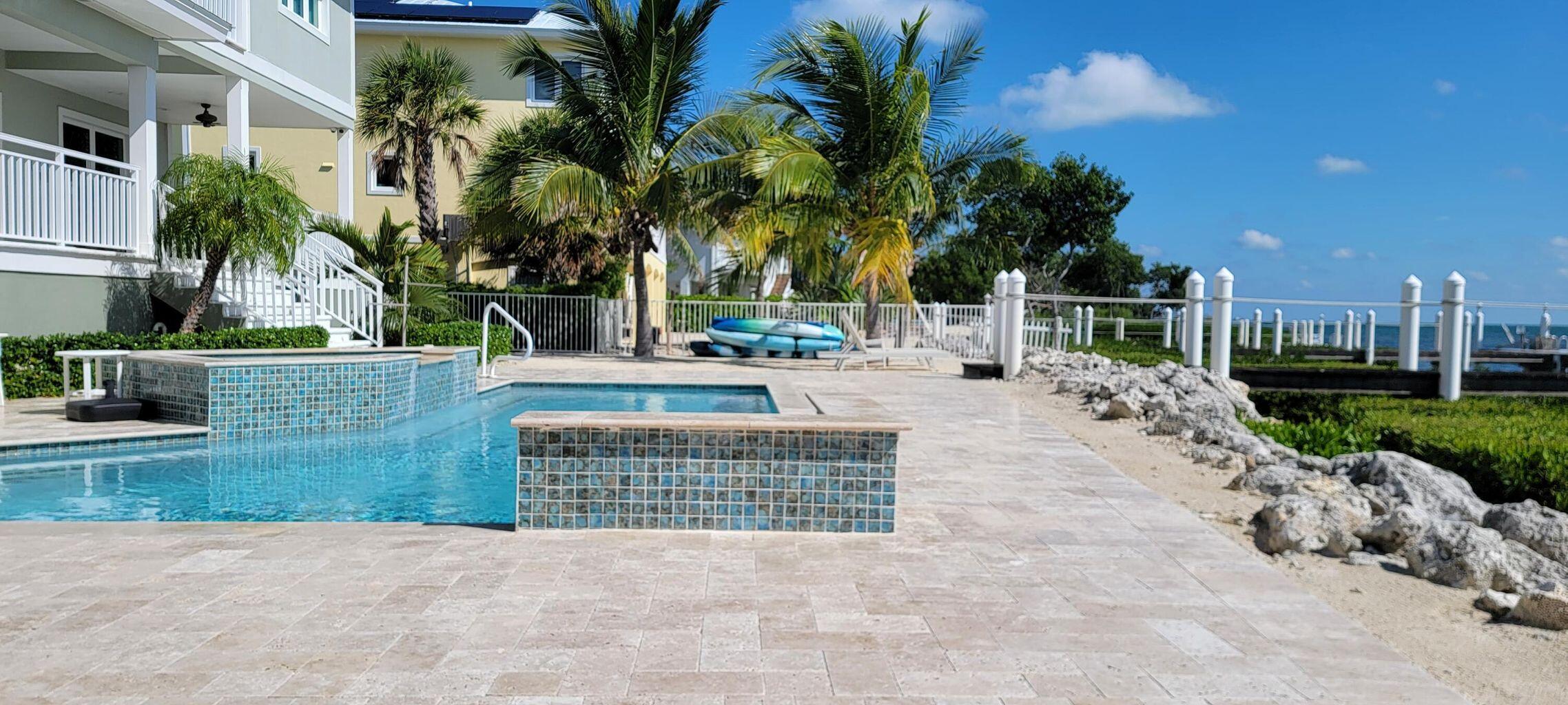 101 Windy Point Circle Marathon, FL 33050 - Photo 12 of 66 a view of a house with a yard and palm trees