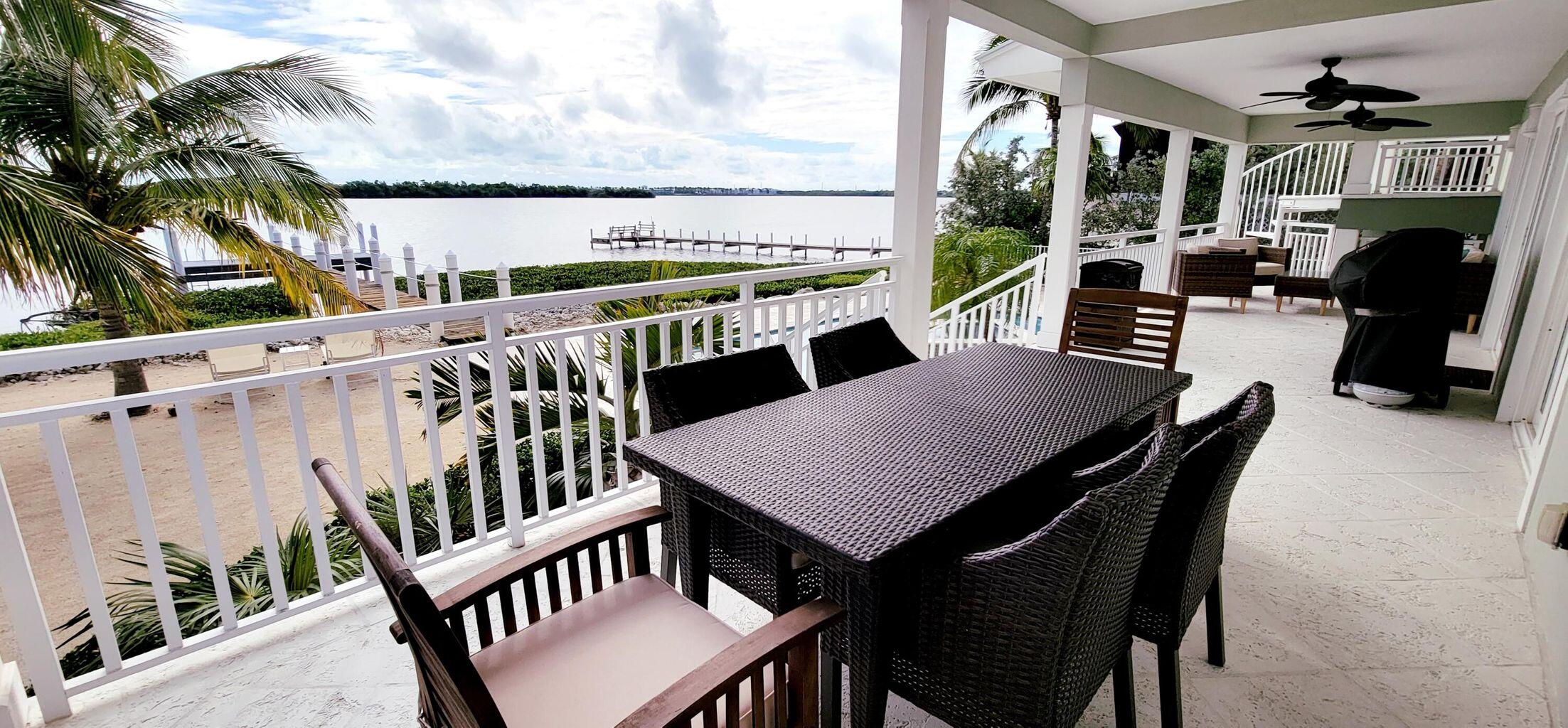 101 Windy Point Circle Marathon, FL 33050 - Photo 13 of 66 a view of a balcony dining area with furniture