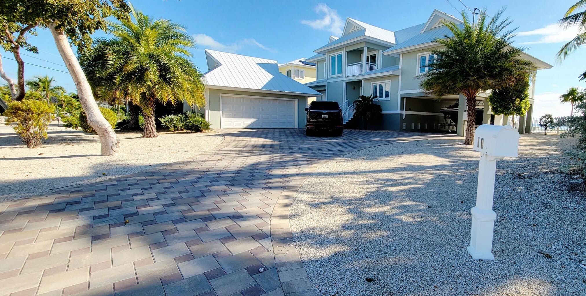 101 Windy Point Circle Marathon, FL 33050 - Photo 17 of 66 a front view of a house with a yard