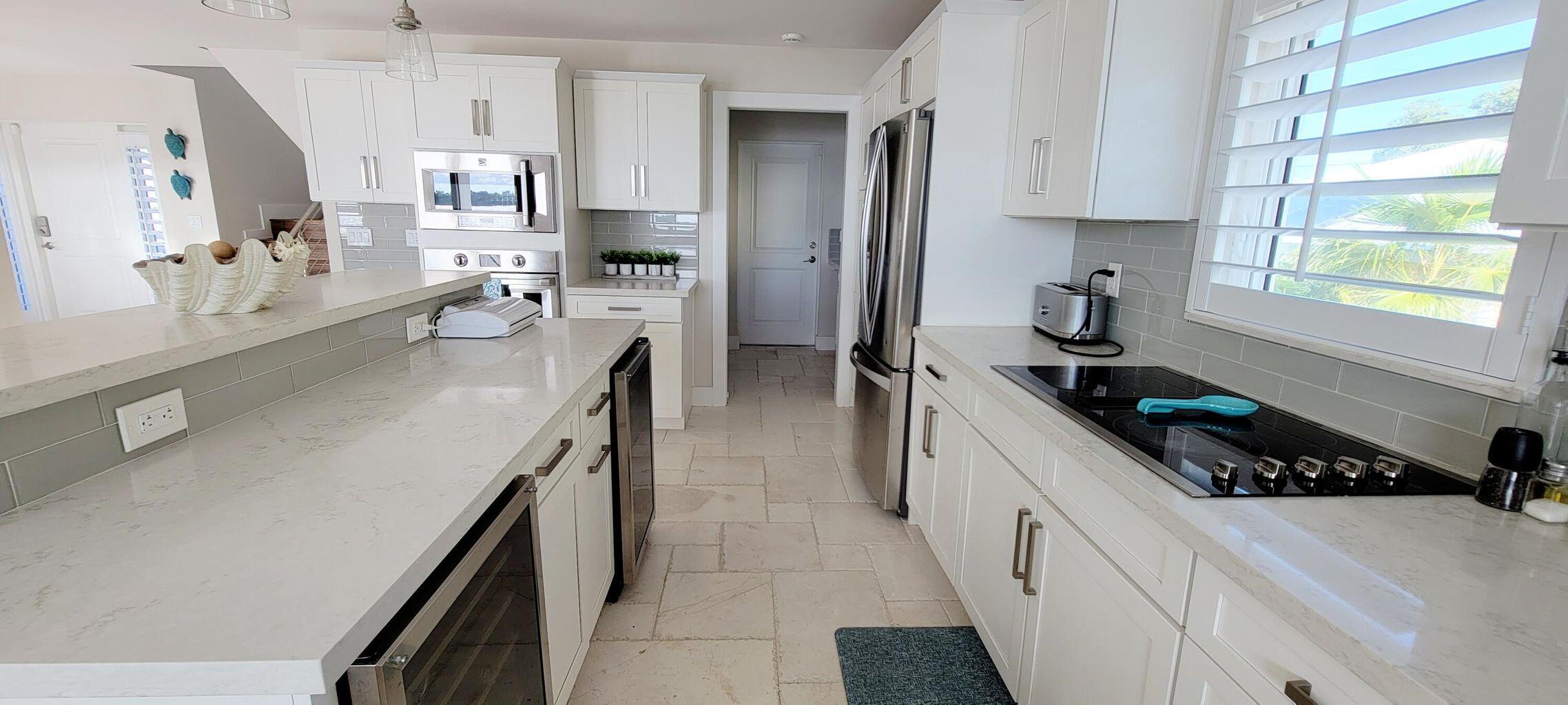 101 Windy Point Circle Marathon, FL 33050 - Photo 32 of 66 a kitchen with stainless steel appliances a sink a stove and a refrigerator