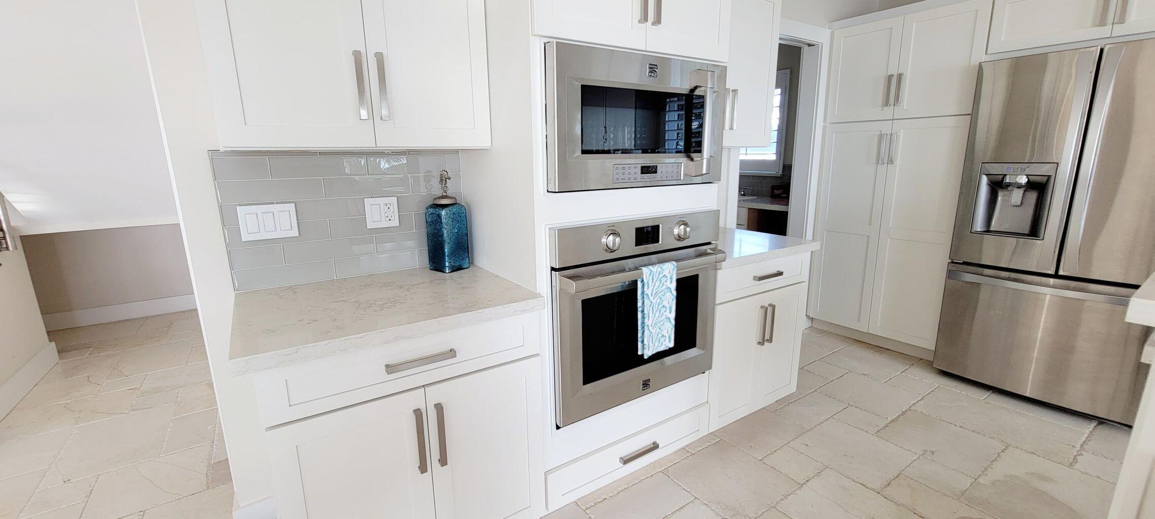 101 Windy Point Circle Marathon, FL 33050 - Photo 33 of 66 a kitchen with stainless steel appliances white cabinets and a refrigerator