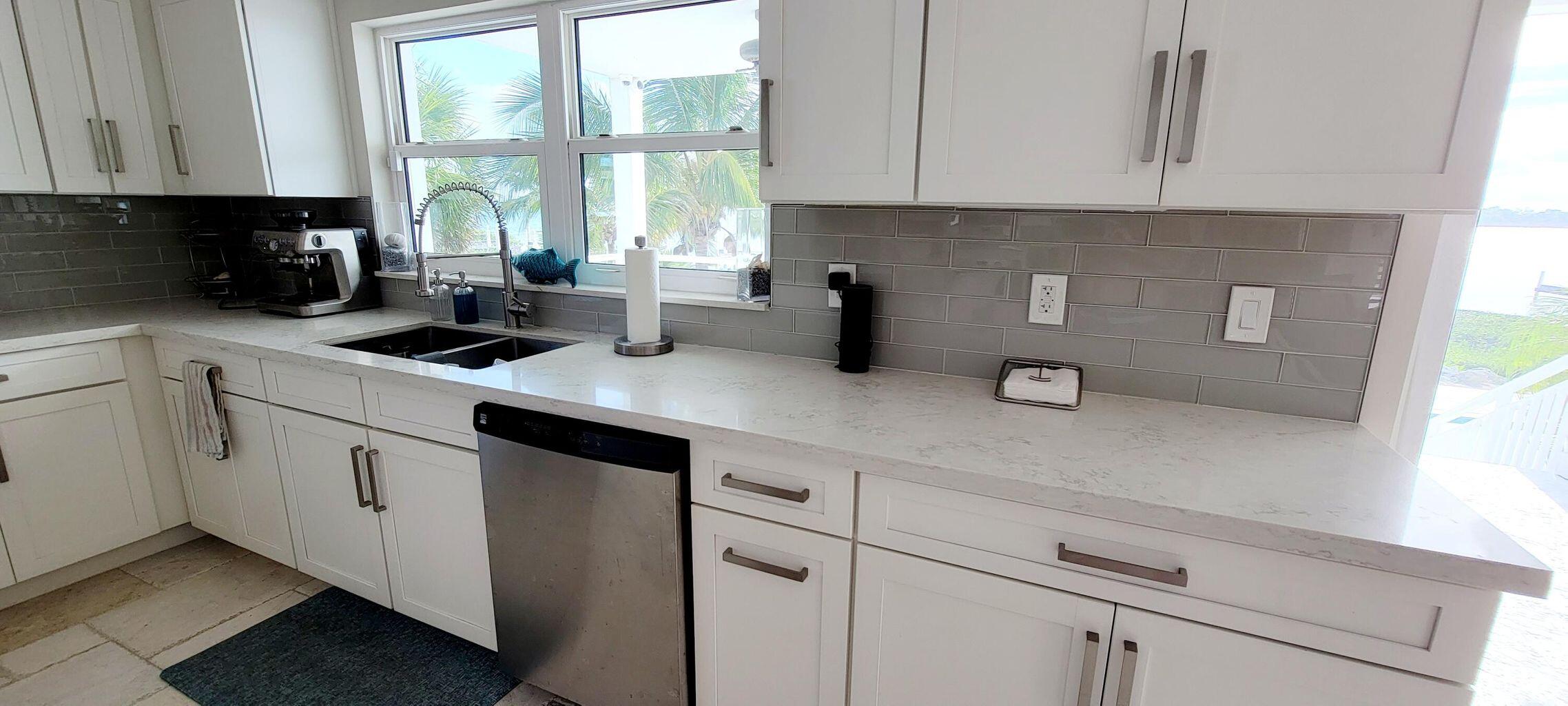 101 Windy Point Circle Marathon, FL 33050 - Photo 35 of 66 a kitchen with white cabinets and white appliances