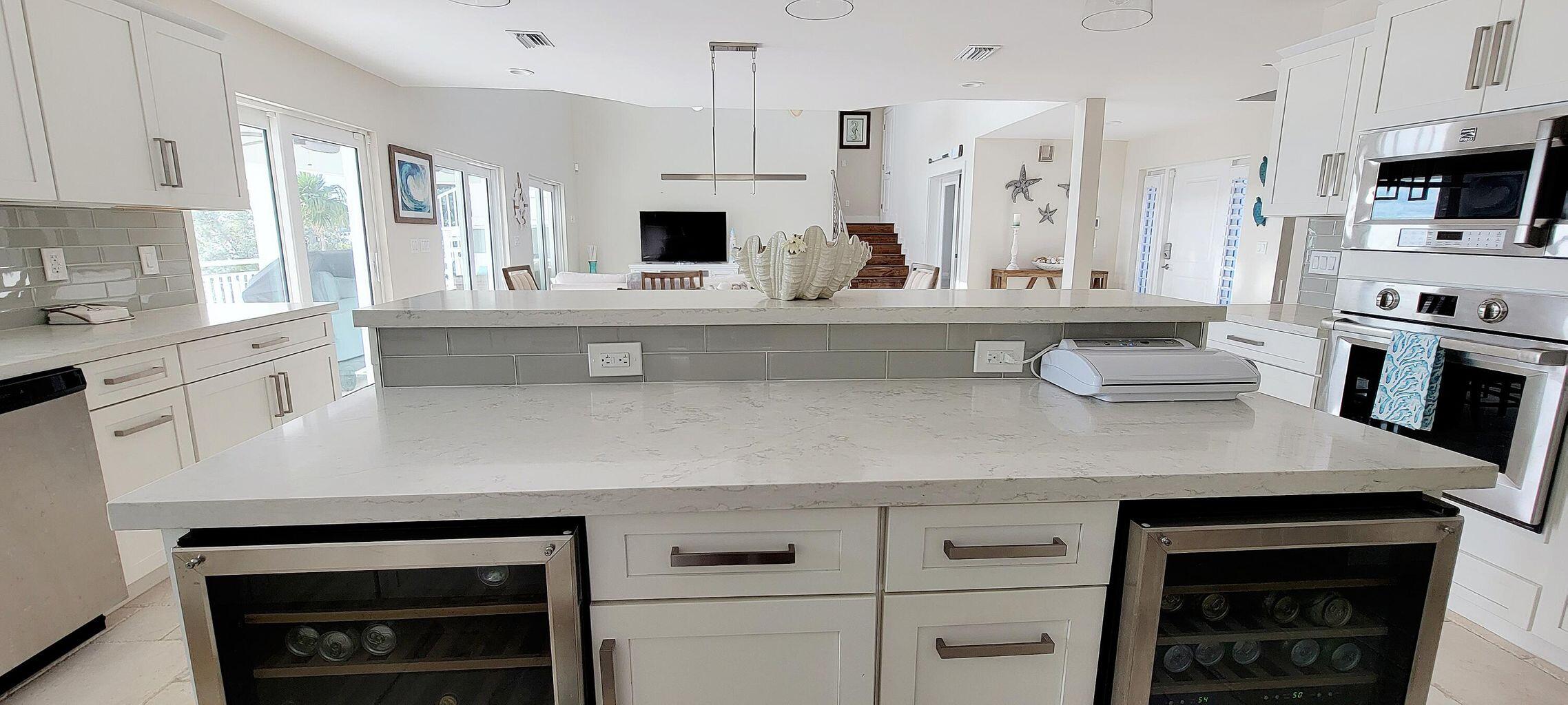 101 Windy Point Circle Marathon, FL 33050 - Photo 36 of 66 a kitchen with stainless steel appliances a stove sink microwave and cabinets