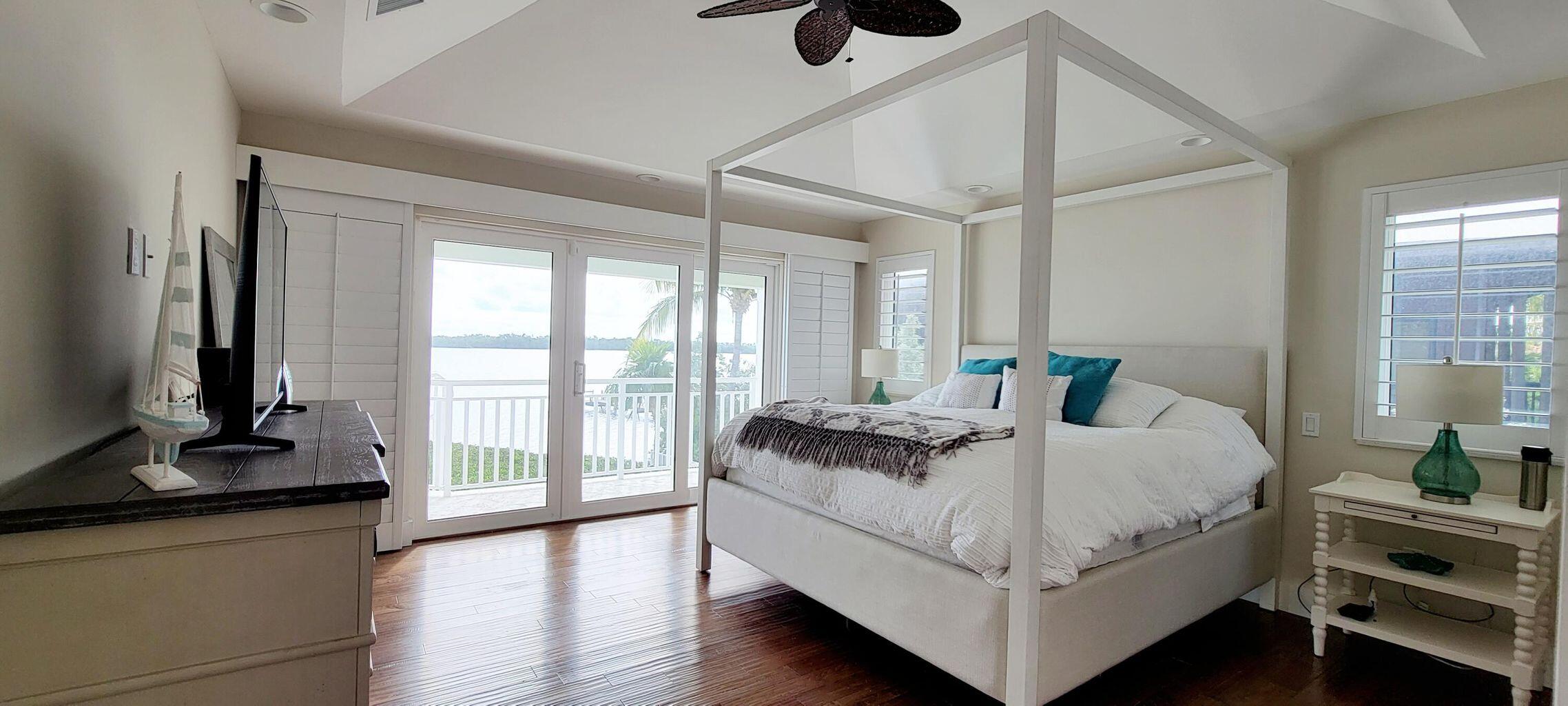 101 Windy Point Circle Marathon, FL 33050 - Photo 48 of 66 a bedroom with a bed and large windows