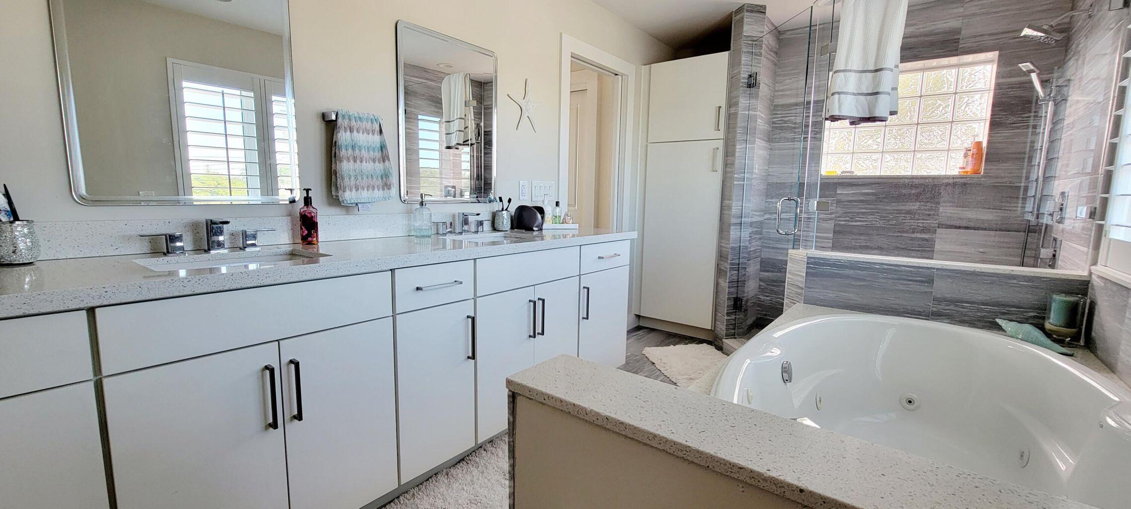 101 Windy Point Circle Marathon, FL 33050 - Photo 50 of 66 a bathroom with a double vanity sink a mirror and a bathtub