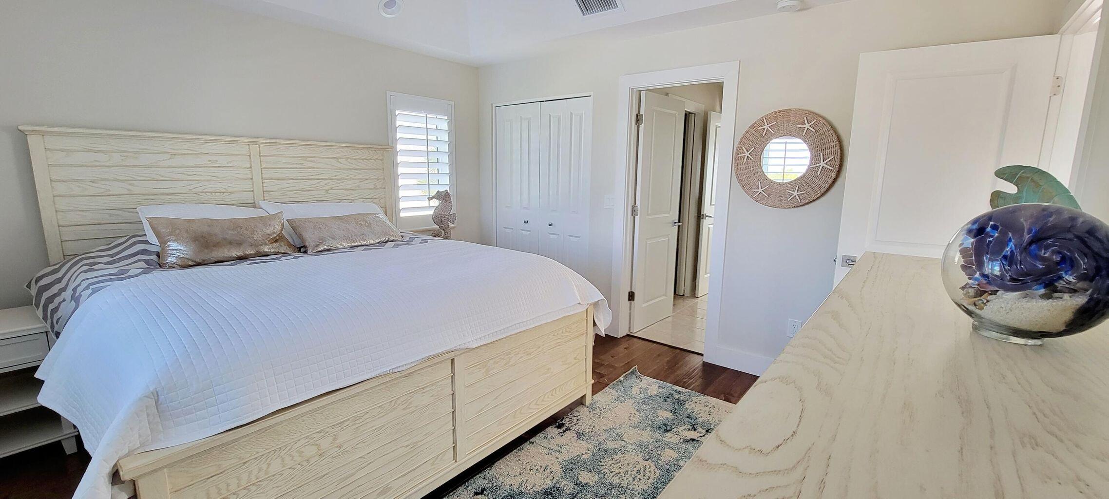 101 Windy Point Circle Marathon, FL 33050 - Photo 52 of 66 a bedroom with a bed and mirror