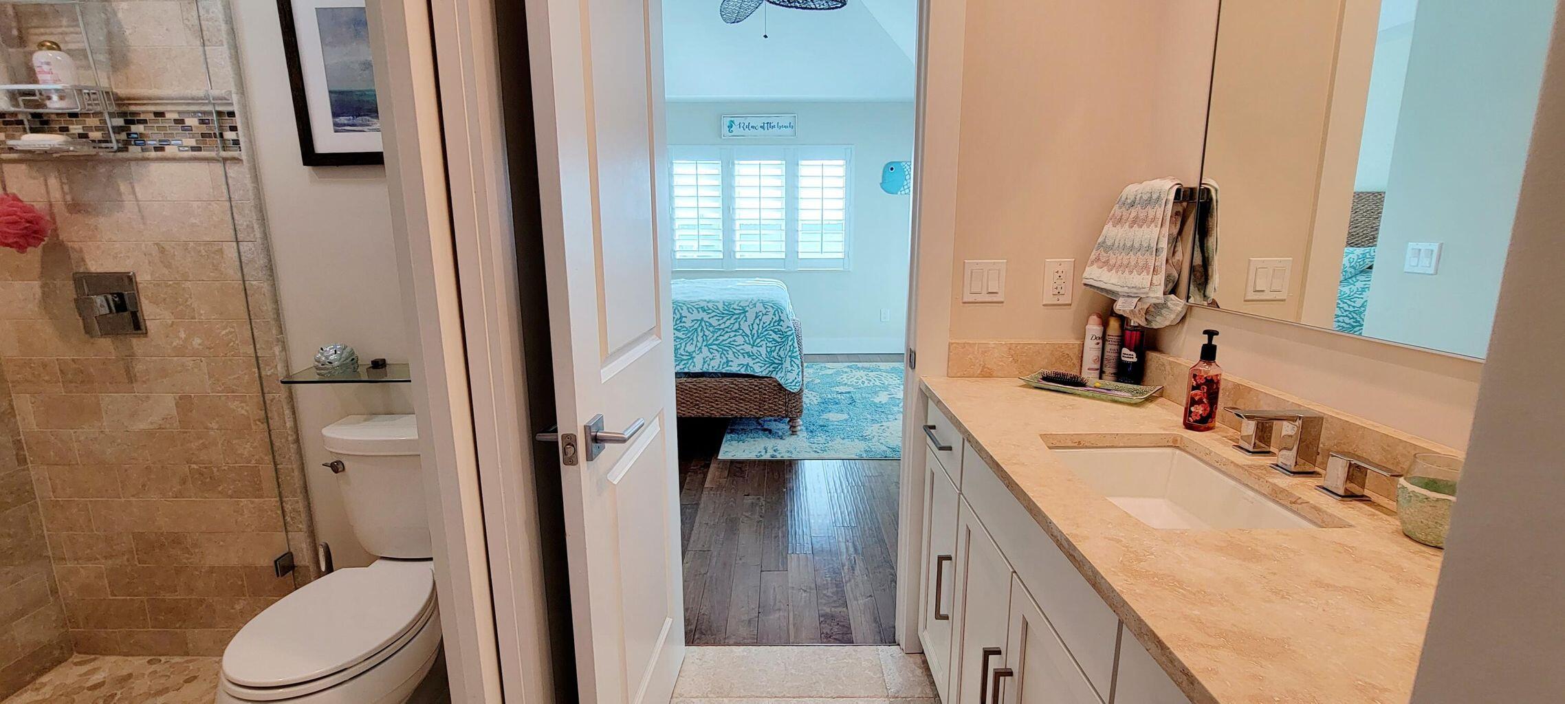 101 Windy Point Circle Marathon, FL 33050 - Photo 56 of 66 a bathroom with a granite countertop sink a toilet and shower