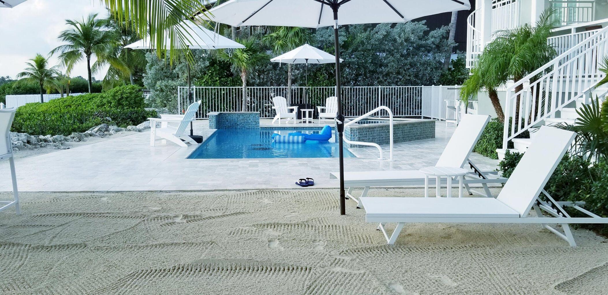 101 Windy Point Circle Marathon, FL 33050 - Photo 10 of 66 a view of backyard with swimming pool and furniture